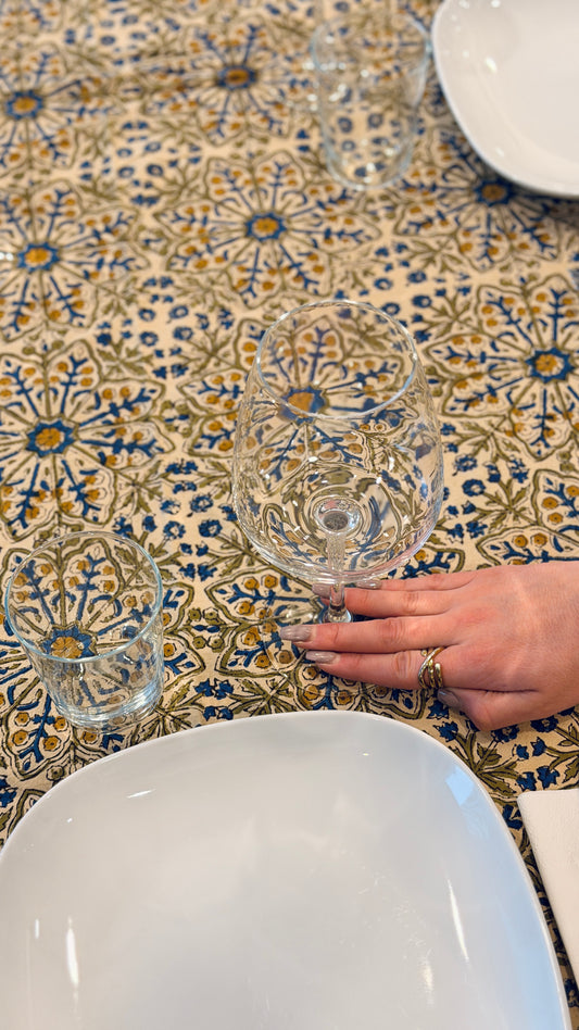 Hand-printed ivory block print cotton tablecloth 150x220cm (60x87 inches): dense floral pattern in green, indigo blue, and mustard yellow with a trimmed border.