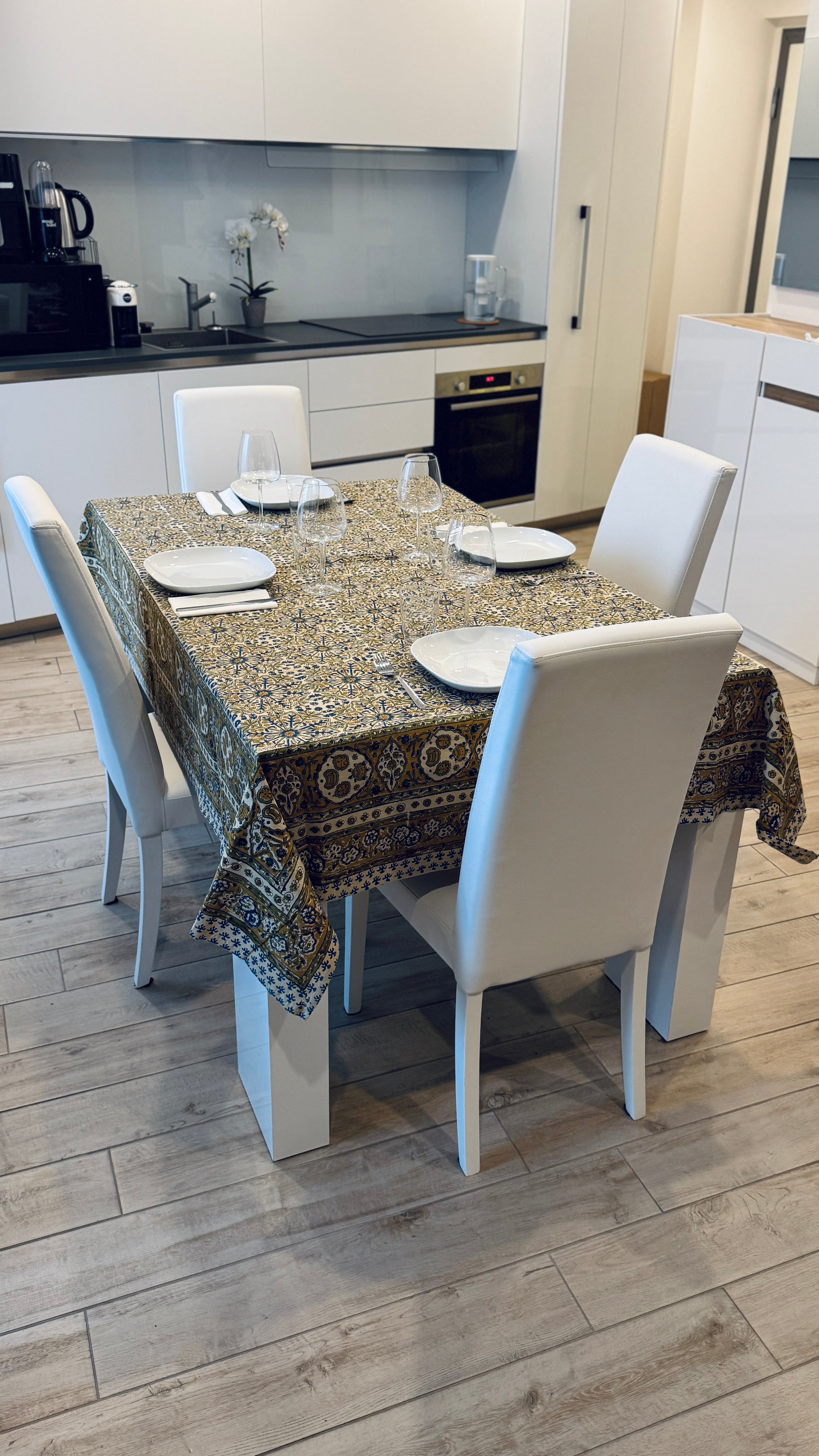Hand-printed ivory block print cotton tablecloth 150x220cm (60x87 inches): dense floral pattern in green, indigo blue, and mustard yellow with a trimmed border.