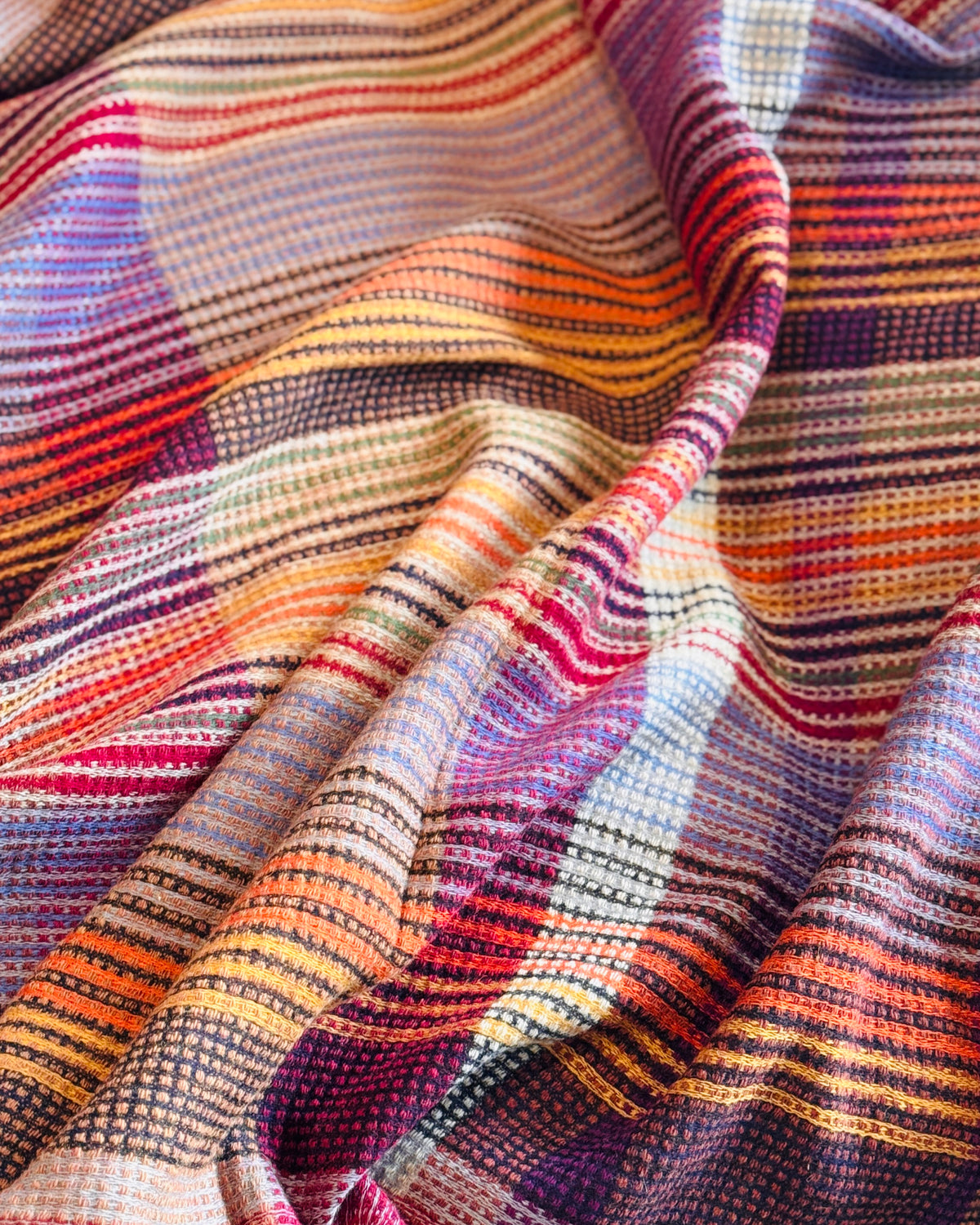 Pieghe del plaid a quadri in lana merino, righe viola, rosse e arancio