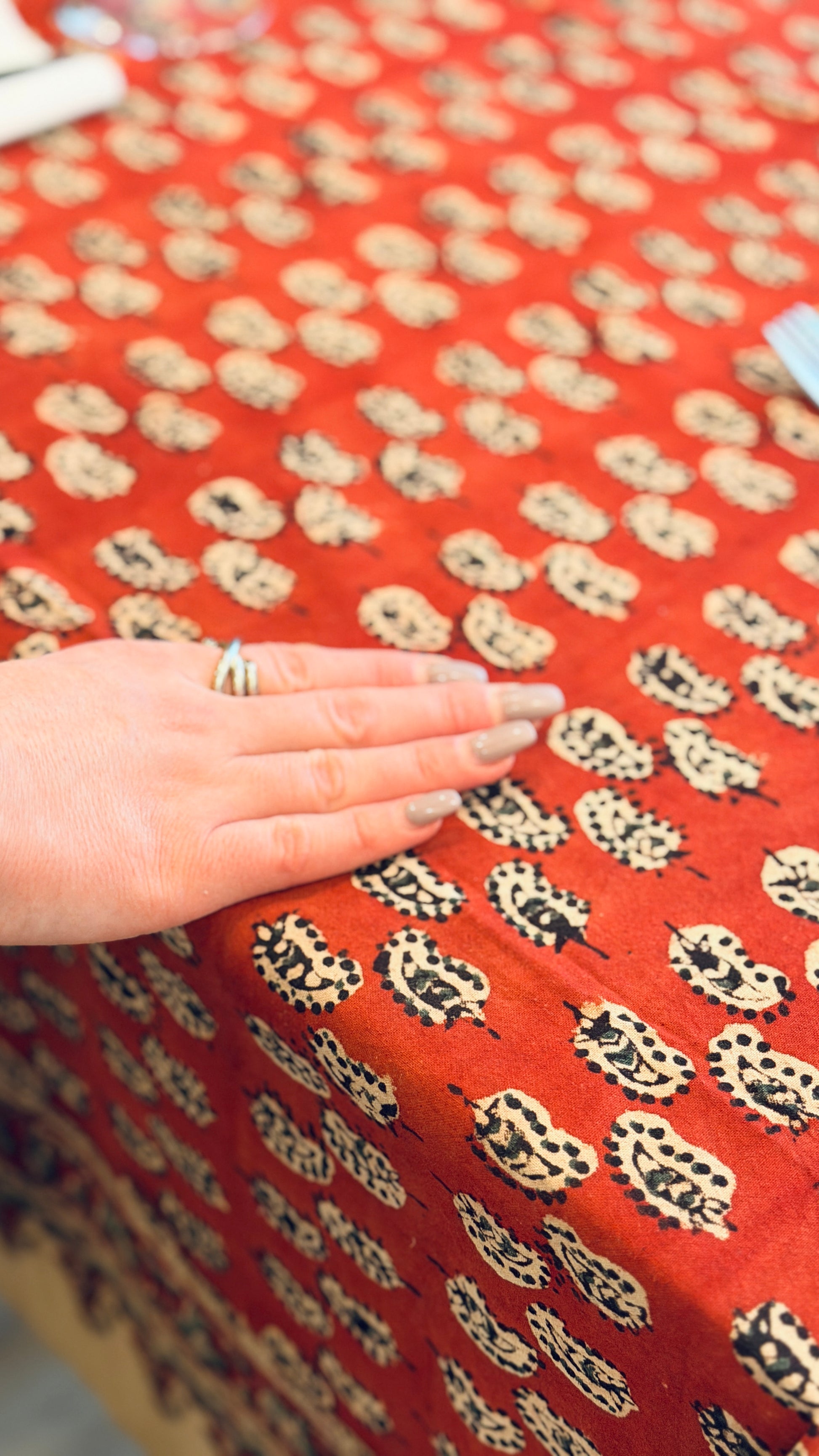 Hand-printed brick red and cream block print cotton tablecloth 150x220cm (60x87 inches): geometric stylized pattern with intricate floral cream border.