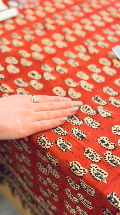 Hand-printed brick red and cream block print cotton tablecloth 150x220cm (60x87 inches): geometric stylized pattern with intricate floral cream border.