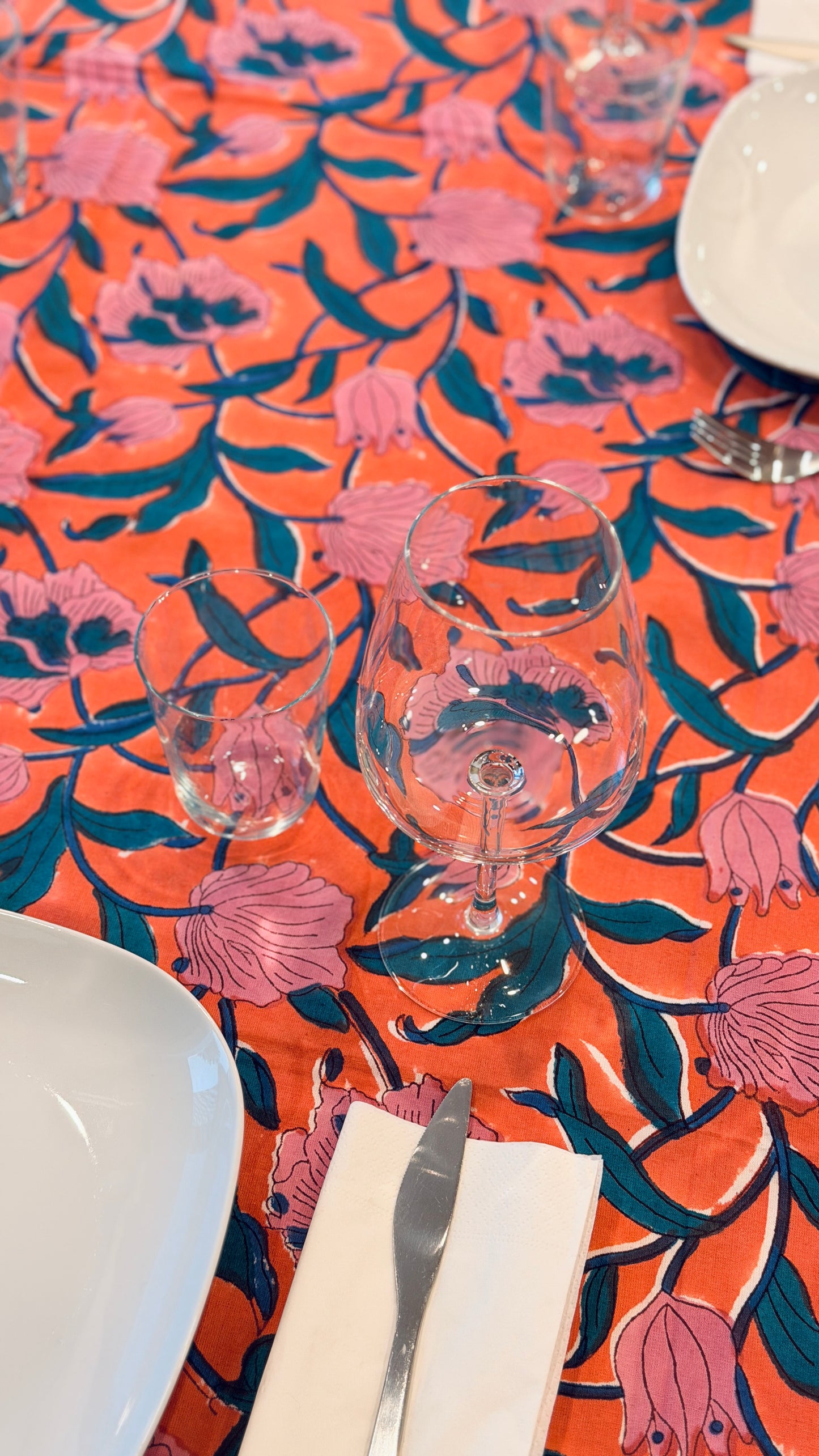 Hand-printed coral orange and pink block print cotton tablecloth 150x220cm (60x87 inches): vibrant large floral pattern with contrasting blue border.