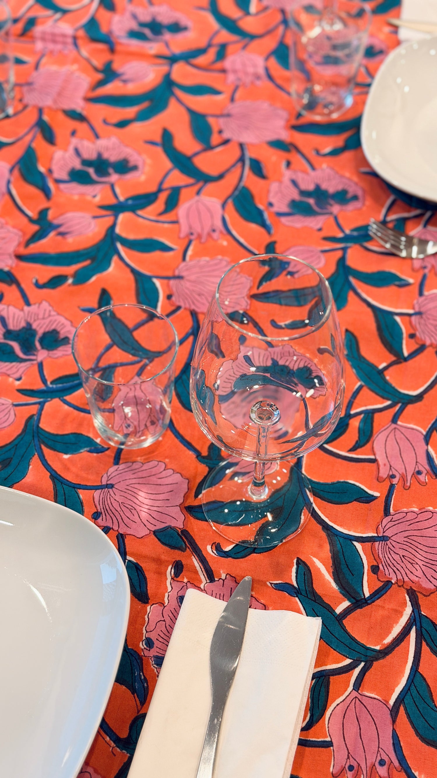 Hand-printed coral orange and pink block print cotton tablecloth 150x220cm (60x87 inches): vibrant large floral pattern with contrasting blue border.