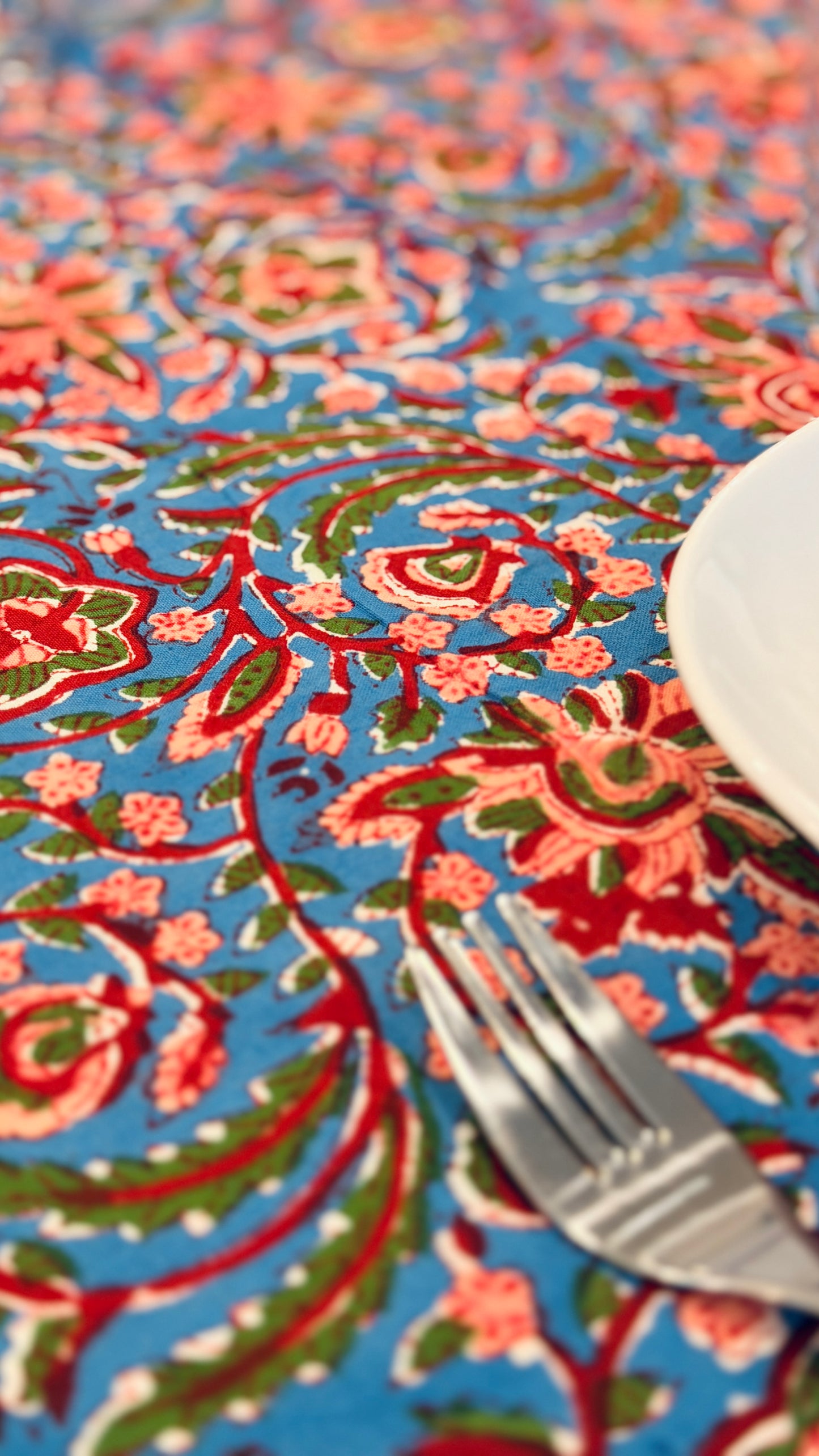 Hand-printed bright turquoise block print cotton tablecloth 150x220cm (60x87 inches): dense floral pattern in coral and red with a striped blue and white border.