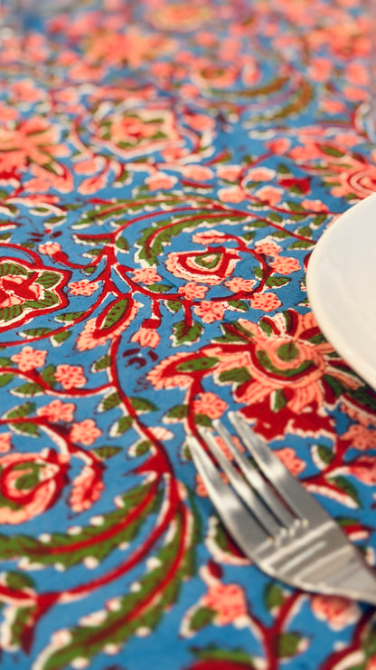 Hand-printed bright turquoise block print cotton tablecloth 150x220cm (60x87 inches): dense floral pattern in coral and red with a striped blue and white border.