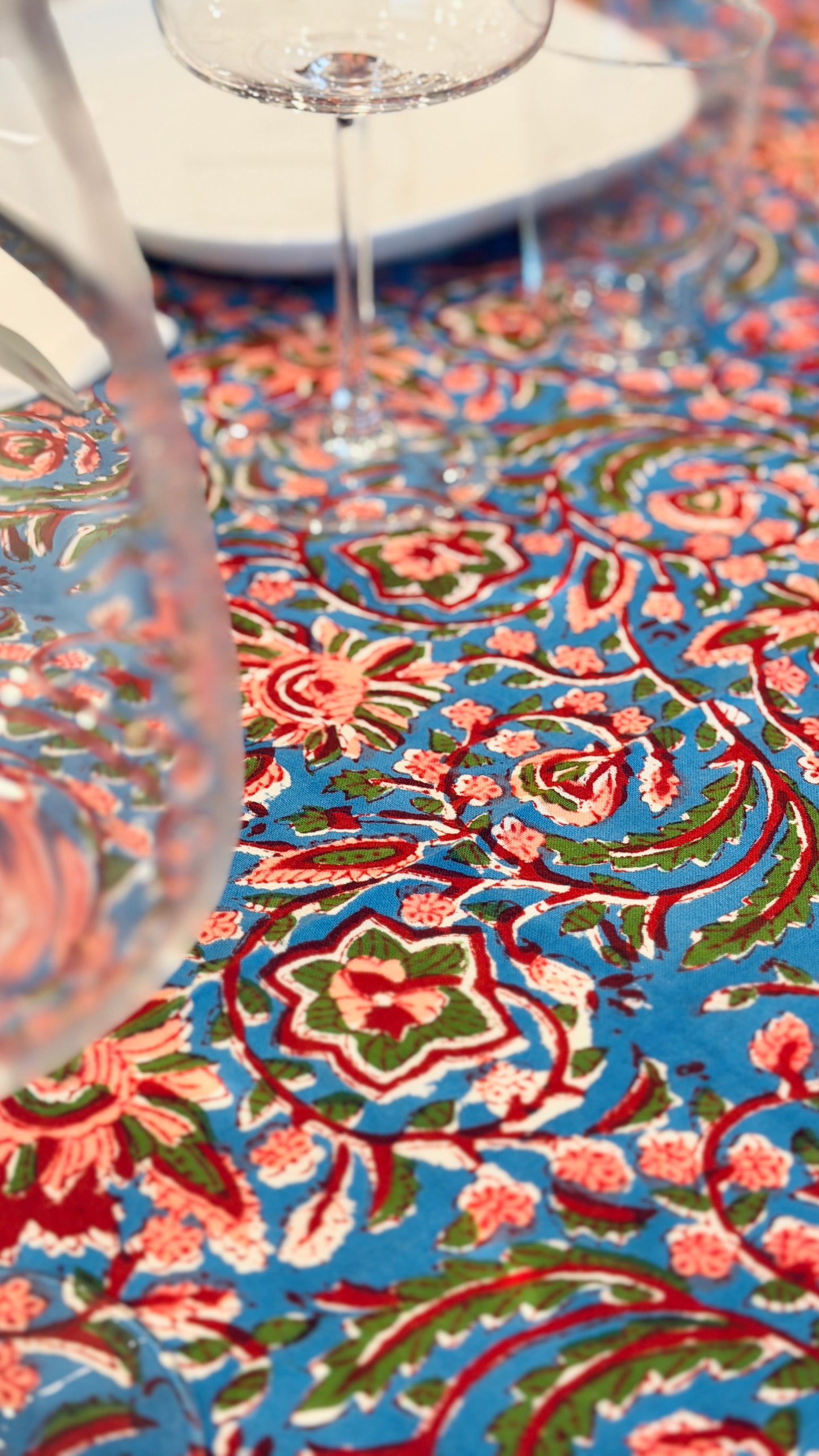 Hand-printed bright turquoise block print cotton tablecloth 150x220cm (60x87 inches): dense floral pattern in coral and red with a striped blue and white border.