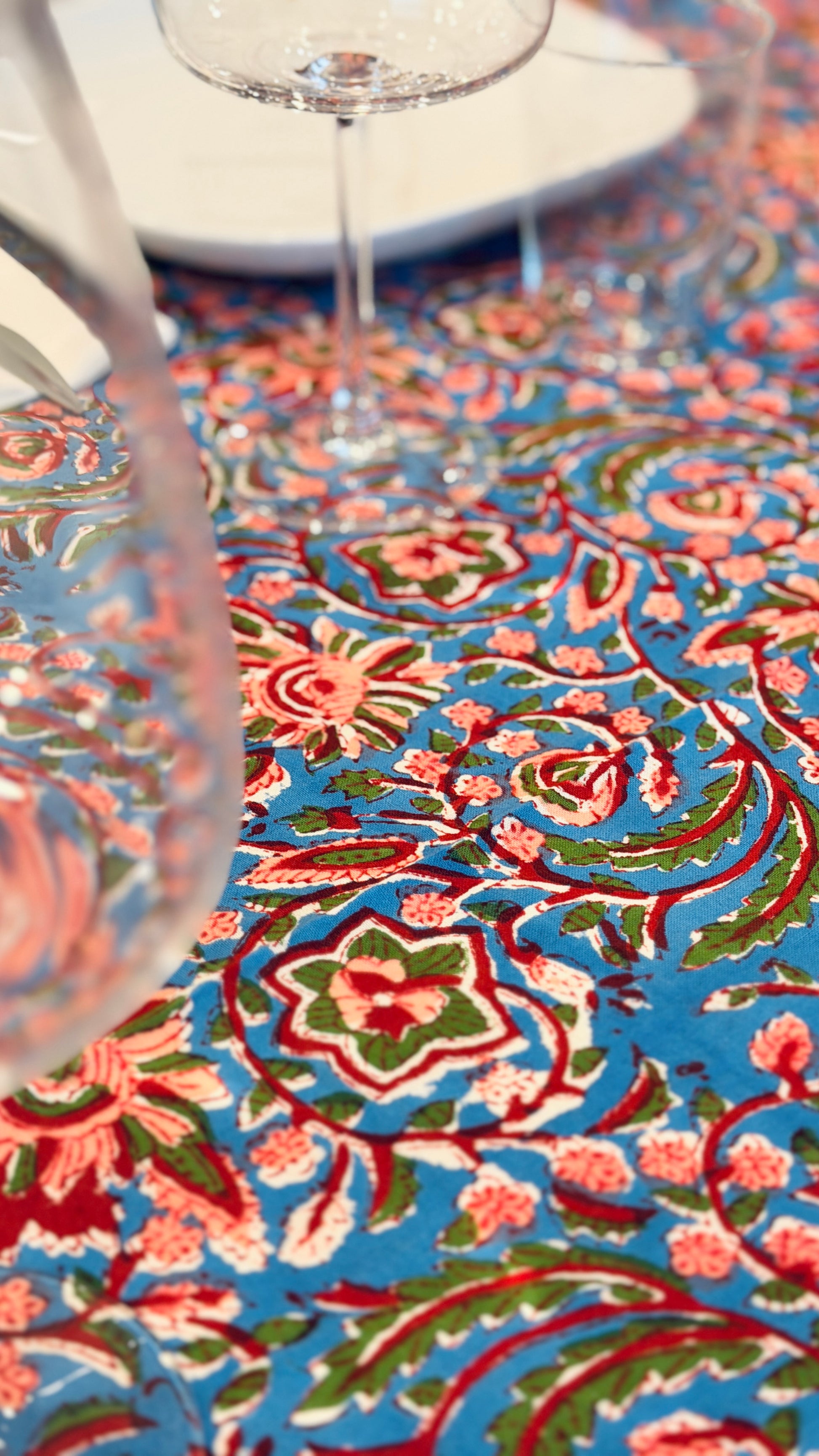 Hand-printed bright turquoise block print cotton tablecloth 150x220cm (60x87 inches): dense floral pattern in coral and red with a striped blue and white border.