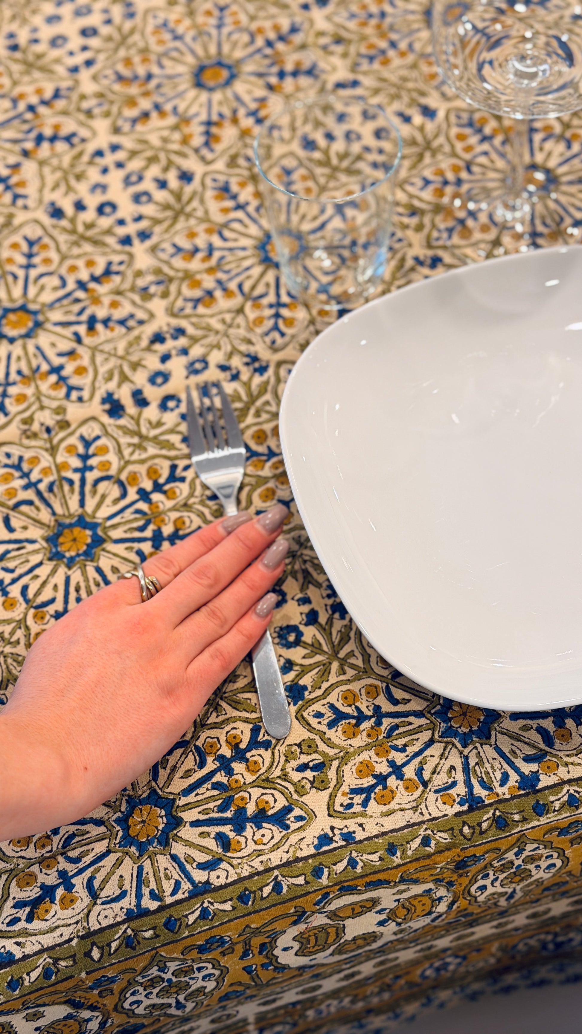 Hand-printed ivory block print cotton tablecloth 150x220cm (60x87 inches): dense floral pattern in green, indigo blue, and mustard yellow with a trimmed border.