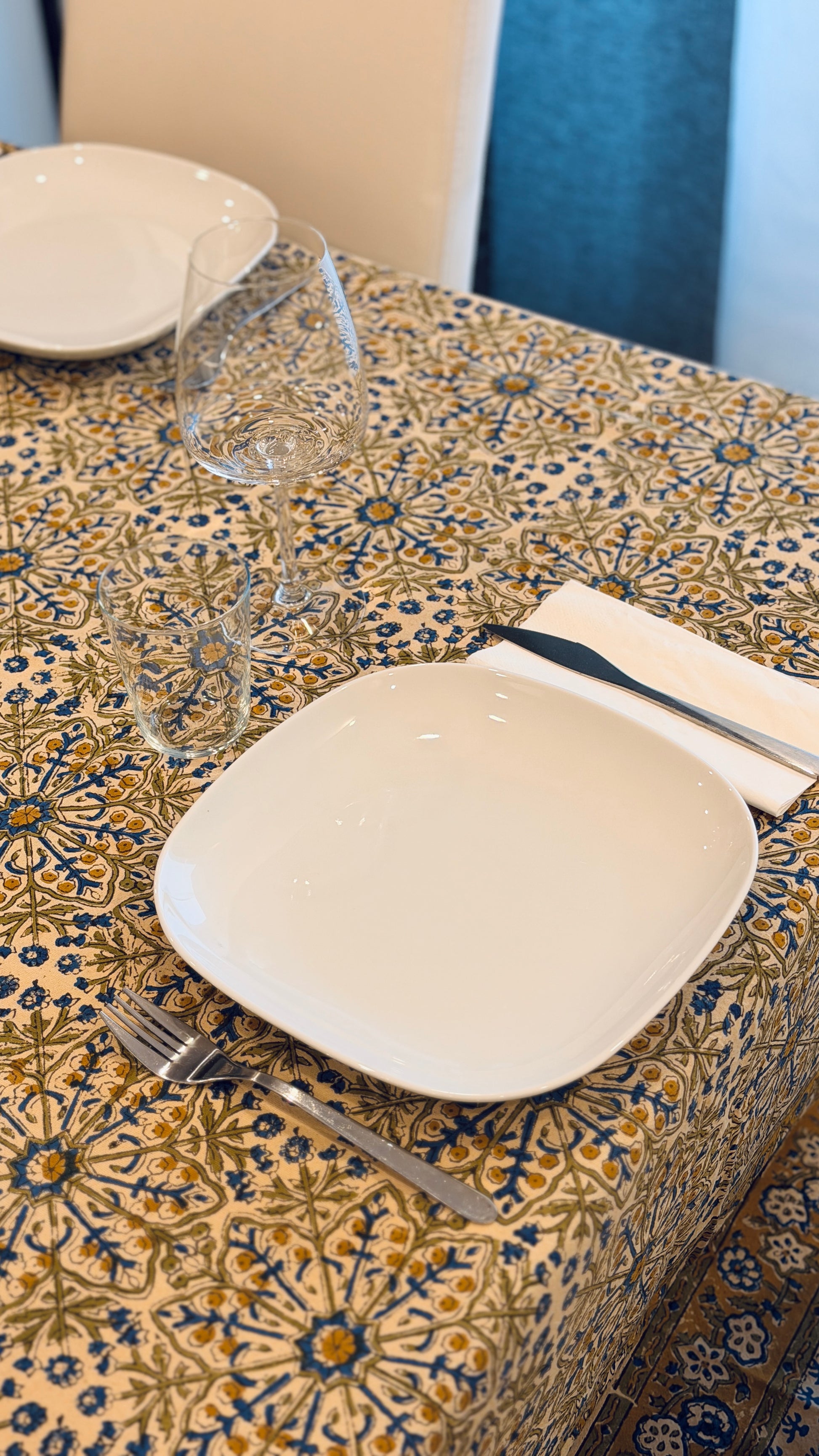 Hand-printed ivory block print cotton tablecloth 150x220cm (60x87 inches): dense floral pattern in green, indigo blue, and mustard yellow with a trimmed border.