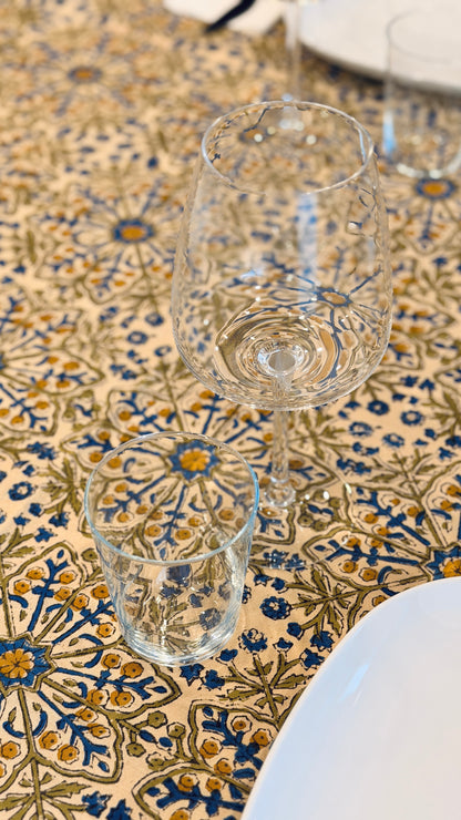 Hand-printed ivory block print cotton tablecloth 150x220cm (60x87 inches): dense floral pattern in green, indigo blue, and mustard yellow with a trimmed border.